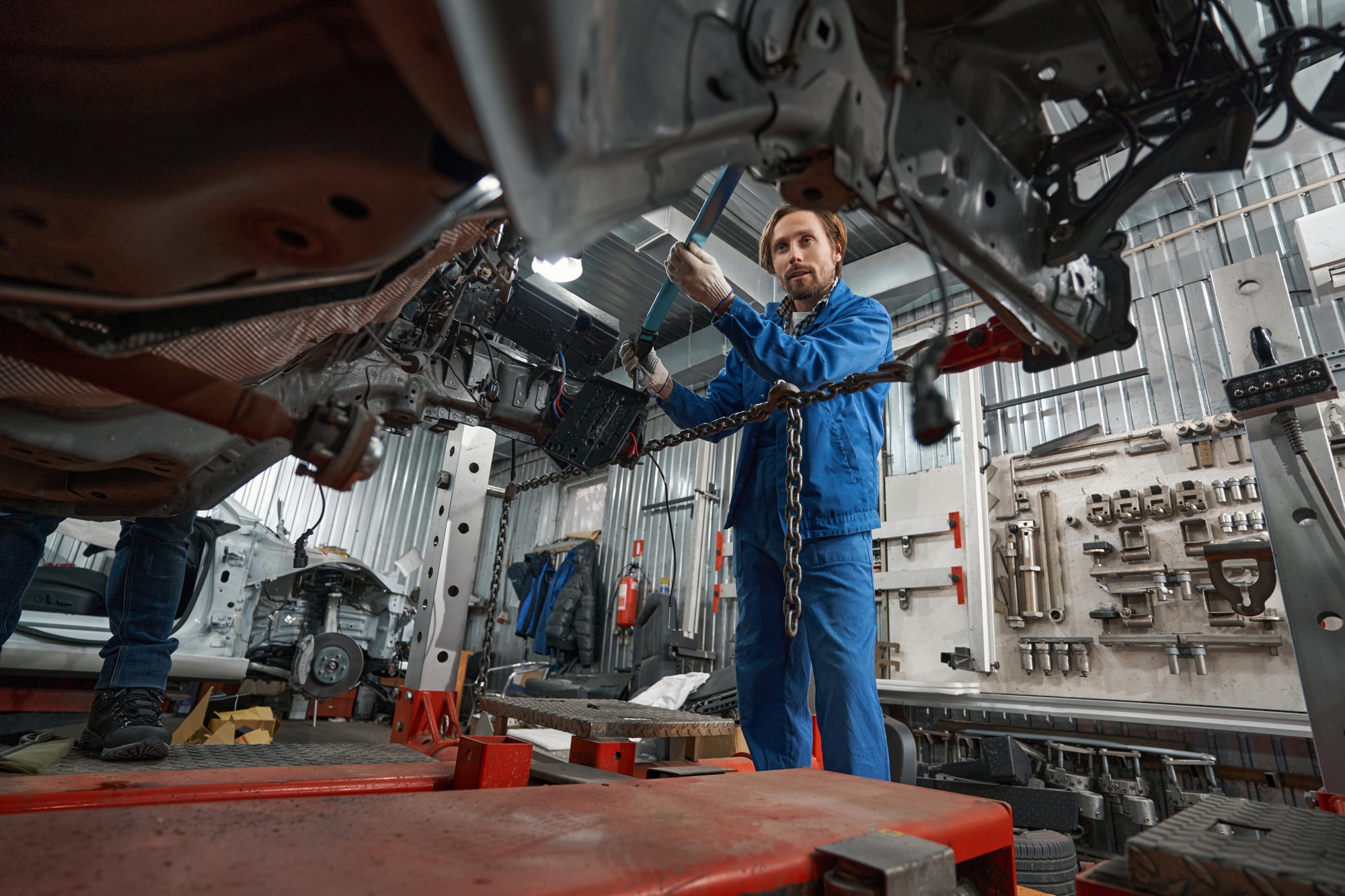 Man holding special tool for auto repair
